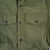 Front detail shot of Men's Topo Designs Insulated Shirt Jacket in Olive green showing chest pockets and buttons.