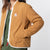 Front model shot of the sherpa jacket in natural/khaki showing the DWR tech fabric unzipped