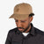 Topo Designs Mountain Ball Cap cotton logo hat in Dark Khaki brown on model.