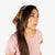 Topo Designs bandana in brick green Tour floral print tied around model's hair