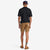 Back of model wearing Topo Designs Men's Mountain organic cotton Shorts in Dark Khaki brown.