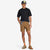 Model wearing Topo Designs Men's Mountain organic cotton Shorts in Dark Khaki brown.